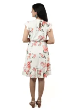 Woman showing the back view of a white floral ruffle dress, keyhole detail