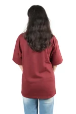 Back view of a woman wearing maroon t-shirt and blue jeans.
