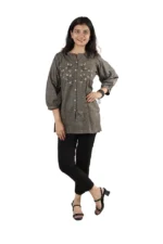 Woman wearing a grey embroidered kurti with black pants, front view, standing and smiling