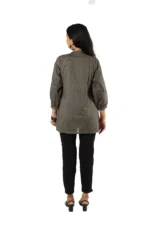 Woman showing the back view of a grey embroidered kurti with black pants, three-quarter sleeves