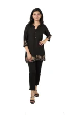 Woman wearing a black kurti with elephant print, front view, standing and smiling