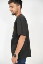 Man in black casual t-shirt posing from left side angle