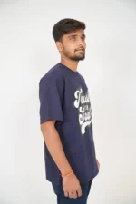 Right-side profile of man wearing navy blue t-shirt and jeans