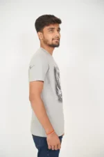 Man in light grey t-shirt standing in right side angle