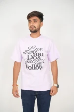 Man wearing lavender t-shirt and jeans in front-facing pose