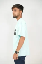 Man in mint green casual t-shirt viewed from the left side