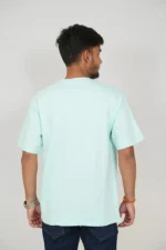 Rear view of man wearing mint blue oversized t-shirt