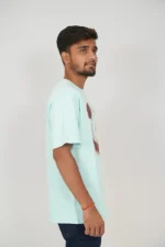 Male side view in mint blue relaxed t-shirt and jeans
