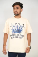 Man wearing light beige oversized t-shirt and blue jeans, front-facing