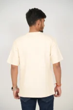 Rear view of man in plain beige short-sleeve t-shirt