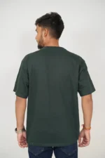 Rear view of man in plain dark green t-shirt