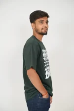 Man posing from right side wearing dark green casual t-shirt