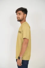 Man in mustard yellow t-shirt viewed from the left, casual side profile