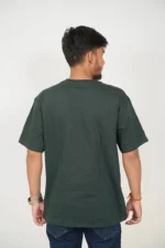 Rear view of man wearing plain dark green t-shirt