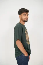 Man wearing dark green t-shirt and jeans, right profile view
