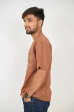Man in plain brown t-shirt viewed from the left side