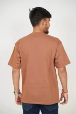 Rear view of man wearing basic brown oversized t-shirt