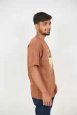 Right side angle of man in casual brown t-shirt and dark jeans