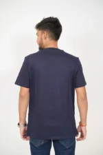 Rear view of man wearing plain navy blue t-shirt and dark jeans