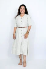 Woman wearing beige striped button-down midi dress, standing front-facing