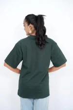 Rear view of woman in oversized dark green t-shirt with ponytail