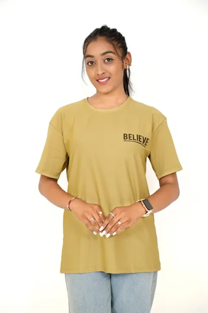 Woman in mustard yellow oversized t-shirt front-facing with light jeans