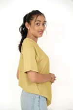Woman wearing plain mustard t-shirt turned to right view