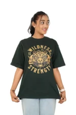 Woman in dark green t-shirt and jeans facing forward, head turned