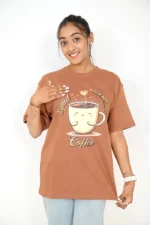 Woman wearing loose brown t-shirt, front-facing with jeans