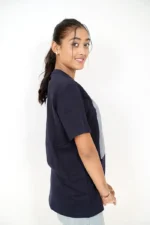 Side profile of woman in navy blue t-shirt and jeans