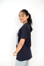 Woman posing in right profile wearing navy blue t-shirt