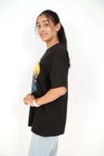 Woman in plain black t-shirt posing from right side