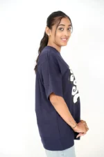 Female model in navy blue casual t-shirt viewed from left side