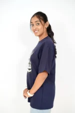 Woman in plain navy blue t-shirt posing from the right side