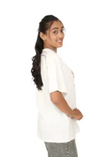 Woman in white t-shirt shown from left-side profile