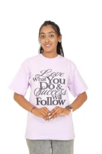 Woman wearing lavender oversized t-shirt and jeans facing straight