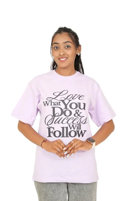 Woman wearing lavender oversized t-shirt and jeans facing straight