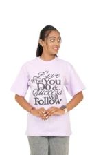 Woman in lavender t-shirt front facing with face turned