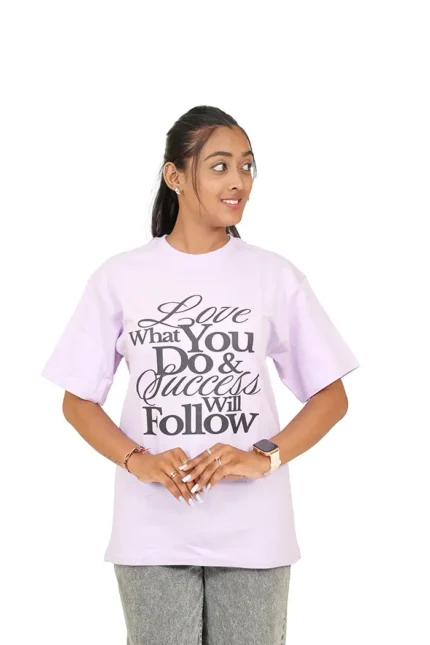 Woman in lavender t-shirt front facing with face turned