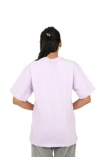 Rear view of woman wearing plain lavender oversized t-shirt
