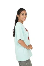 Female model in mint blue t-shirt, left profile view