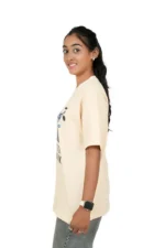 Right-side profile of woman in oversized beige t-shirt