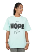 Female model wearing mint green t-shirt looking sideways