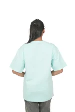 Rear view of woman wearing plain mint green oversized t-shirt